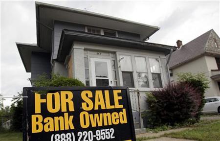 A "For Sale- Bank Owned" sign sits in front of a home in Pontiac, Michigan June 19, 2009. REUTERS/Rebecca Cook